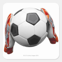 Two goal keepers gloves holding a football stickers