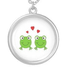 Two green frogs with red hearts. jewelry
