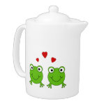 Two green frogs with red hearts.