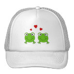 Two green frogs with red hearts. trucker hat