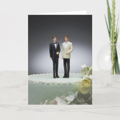 Two groom figurines on top of wedding cake greeting card