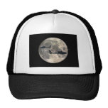 two helicopters silhouetted by a full moon mesh hats