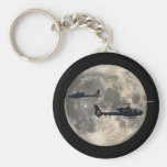 two helicopters silhouetted by a full moon key chain