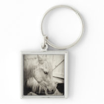 two horses outside a stable- black and white key chain