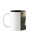 Two little girls kissing mug