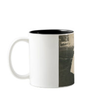 Two little girls kissing mug