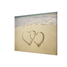 Two overlying hearts drawn on the beach stretched canvas prints