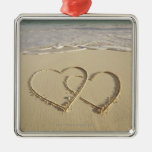Two overlying hearts drawn on the beach ornament