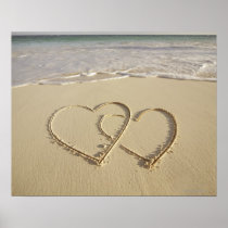 Two overlying hearts drawn on the beach with print