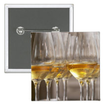 two rows of wine tasting glasses with lucious buttons