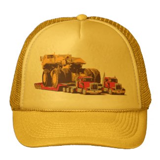 Two Semi Big Trucks carrying a Huge Mining Truck Hat
