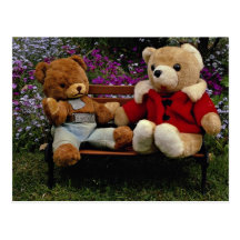 Two smokey bear dolls placed in garden bench postcard