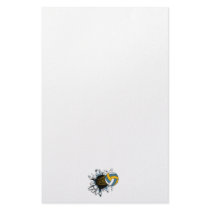 volleyball ripping through blue and gold stationery paper