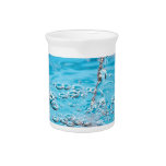 Water Flowing into a Pool Drink Pitcher