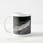 Water flowing through the rocks mug