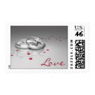 postcard - Love postage stamps, with silver wedding rings and red hearts. postcard - Love postage stamps, with silver wedding rings and red hearts.