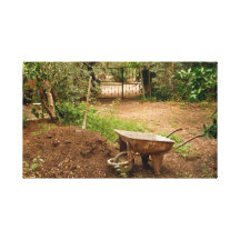 Wheel Barrow Next To Soil Heap Canvas Prints