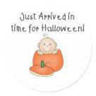 round_sticker - An adorable baby with one curly hair sits inside an orange pumpkin on customizable Halloween T-shirts, magnets, greeting cards, tote bags, and other items that are perfect for babys first Halloween!: Sizes 