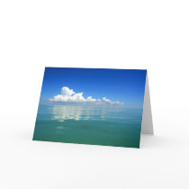 White cloud over a placid ocean card