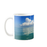 White cloud over a placid ocean coffee mug