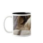 White dog hiding behind bed (differential focus) coffee mug