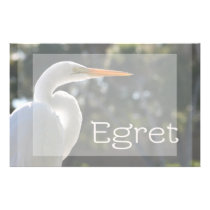 White Egret text backlit looking right against stationery