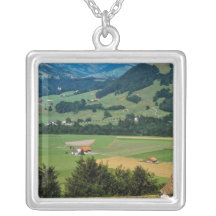 White The flowered courtyard of Gruyere Castle flo Necklaces