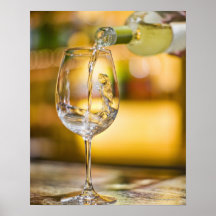 White wine is poured from bottle in restaurant. print