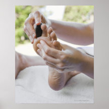Woman getting foot massage with hot stone poster