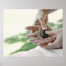 Woman getting hand massage with hot stone posters