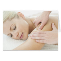 Woman relaxing at a spa while receiving a 2 card