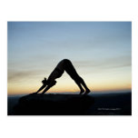 woman silhouetted against the sunset practicing post cards