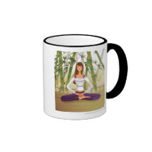 Woman sitting in lotus position, meditating coffee mugs