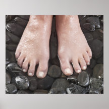 Woman's feet on pebbles posters