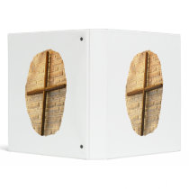 Wooden thin cross on white brick church wall vinyl binder