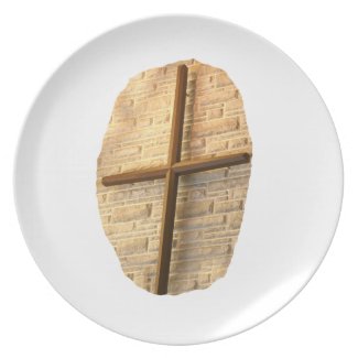 Wooden thin cross on white brick church wall plate