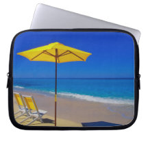 Yellow beach umbrella and chairs on pristine laptop computer sleeves
