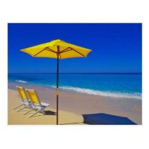 Yellow beach umbrella and chairs on pristine post card