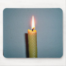 Yellow Candle flame against white wall Mousepad