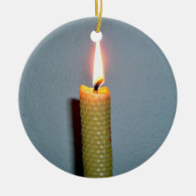 Yellow Candle flame against white wall Christmas Tree Ornament