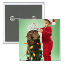 Young boy wrapping Christmas lights around a dog