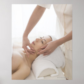 Young woman having facial massage poster