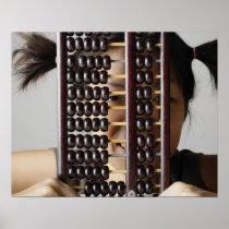 Young woman peering through abacus. posters