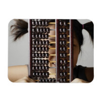Young woman peering through abacus. vinyl magnets