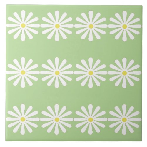 12 white daisies with yellow centres on mint green ceramic tile
