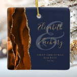 1st Christmas Married Burnt Orange Agate Navy Blue Ceramic Ornament<br><div class="desc">This elegant modern ornament features a burnt orange watercolor agate design trimmed with faux gold glitter. Easily customize the gold-colored text on a navy blue background, with the names of the bride and groom in whimsical handwriting calligraphy over a large ampersand. The words "First Christmas Married" appear in serif font...</div>
