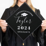 2024 Graduate Minimalist Black Custom Graduation Graduation Cap Topper<br><div class="desc">Stylish custom graduation cap topper design features modern and minimalistic style congratulations wording that can be personalized with your graduate's name in script and their graduation class year. Note,  white text / grad cap image and black background colors can be modified.</div>