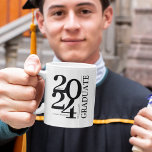 2024 Graduate Trendy Black Graduation Coffee Mug<br><div class="desc">Be the ultimate, most thoughtful gift-giver and give the modern Graduate Typographic Graduation Mug this upcoming graduation season. Perfect for class of 2024, this mug has been designed with special attention to detail. Not only does this mug feature a bold typography design for the class year, but it also has...</div>