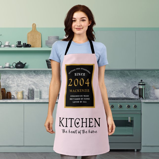 21st Birthday 2004 Name Pink Kitchen Heart Of Home Apron (Personalized Pink 21st birthday apron worn by a woman in the kitchen)