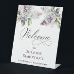 21st Birthday Purple Lilac Spring Flower Welcome Pedestal Sign<br><div class="desc">Soft watercolor purple lilacs create a pretty springtime 21st birthday welcome pedestal sign. This tabletop sign stands up on its own. Just one less thing to think about, right? The calligraphy adds an elegant touch. This item is part of the Purple Spring Lilac Flower collection. It lets you choose a...</div>